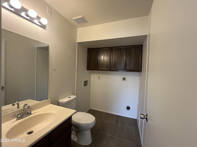 bathroom featuring vanity, tile patterned flooring, and toilet