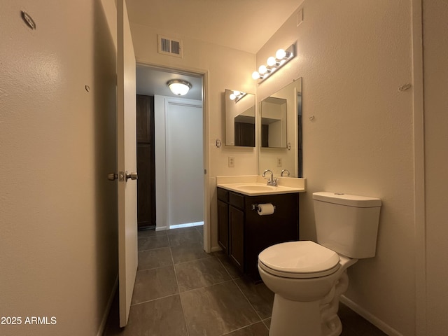 bathroom with tile patterned floors, vanity, and toilet