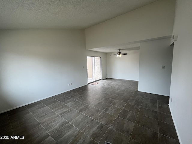 empty room with vaulted ceiling, a textured ceiling, and ceiling fan