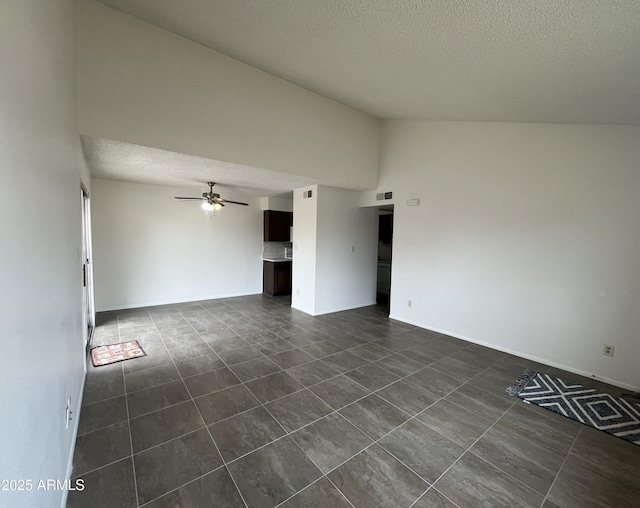 tiled spare room featuring lofted ceiling, a textured ceiling, and ceiling fan