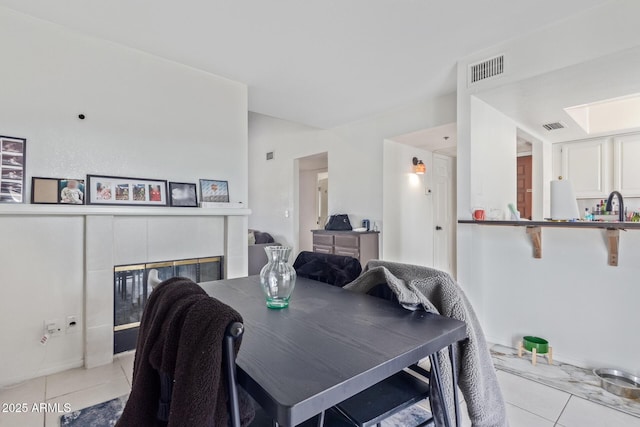 tiled dining space featuring sink