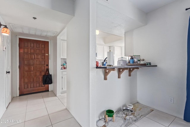 foyer featuring light tile patterned flooring