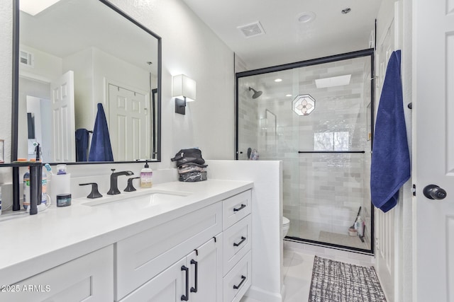 bathroom with walk in shower, vanity, and toilet