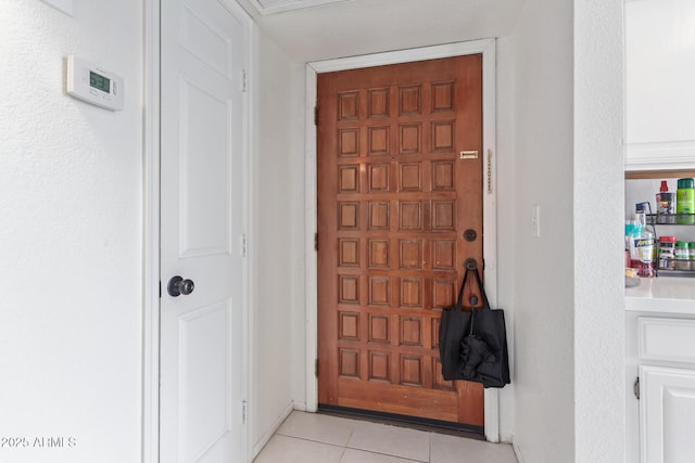 doorway with light tile patterned floors