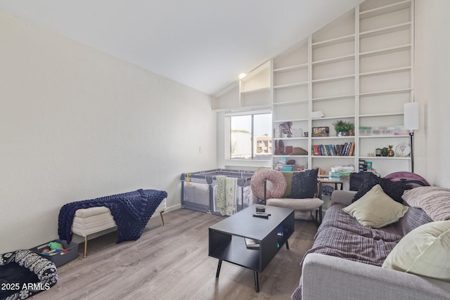 living room featuring hardwood / wood-style floors and high vaulted ceiling