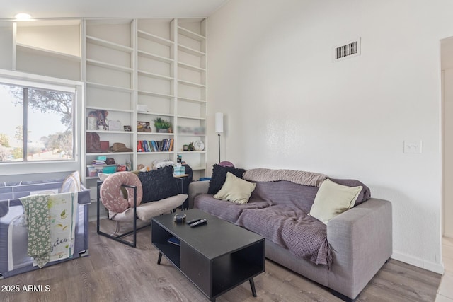 living room with high vaulted ceiling and hardwood / wood-style floors