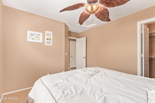 carpeted bedroom with a ceiling fan and baseboards