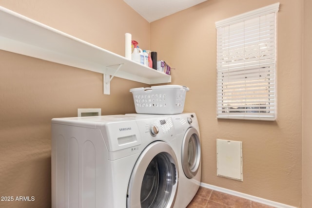 laundry area featuring washer and dryer, tile patterned flooring, laundry area, and baseboards