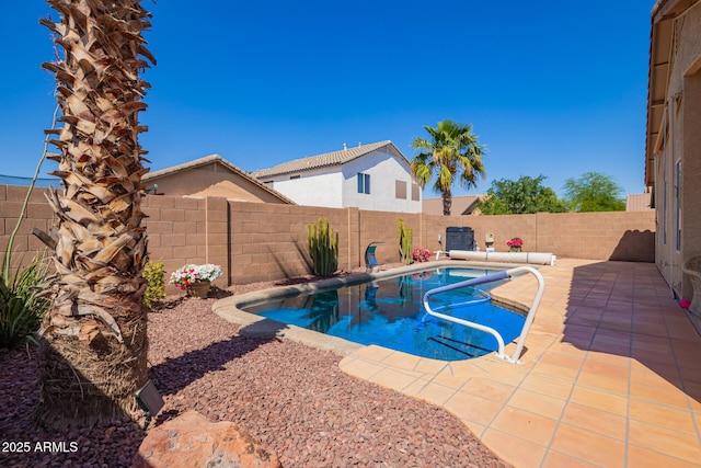 view of swimming pool with a fenced in pool, a fenced backyard, and a patio area