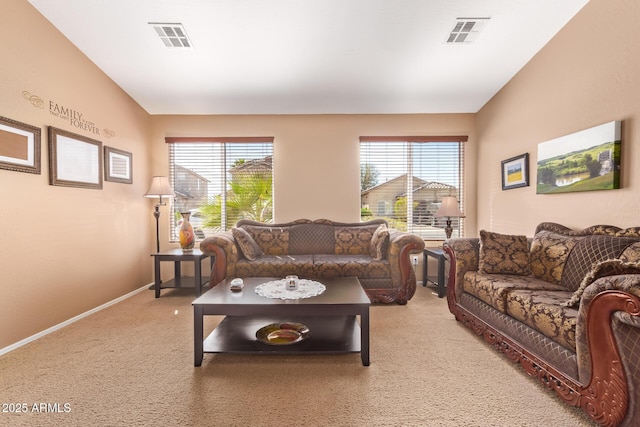 living room featuring light colored carpet, visible vents, and a wealth of natural light