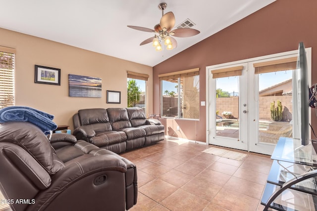 living area with light tile patterned floors, visible vents, vaulted ceiling, french doors, and a ceiling fan