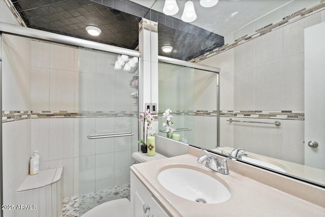 bathroom featuring vanity, an enclosed shower, and toilet