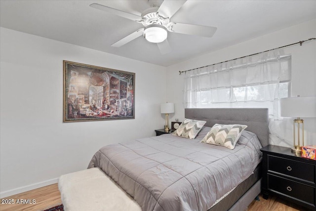 bedroom with ceiling fan and wood-type flooring