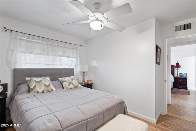 bedroom with wood-type flooring and ceiling fan