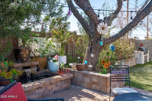 view of patio / terrace featuring grilling area and an outdoor kitchen