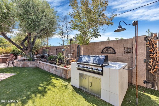 view of patio / terrace with grilling area and fence