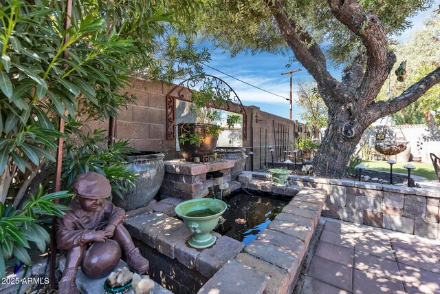 view of patio / terrace featuring fence