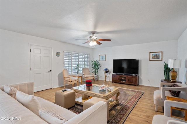 living room with ceiling fan and light wood-type flooring