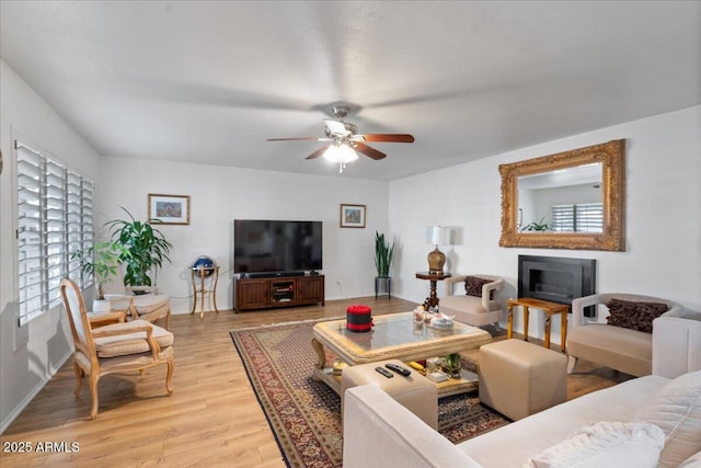 living room featuring ceiling fan and light wood-type flooring