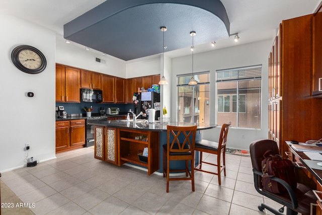 kitchen with sink, pendant lighting, a textured ceiling, light tile patterned floors, and black appliances