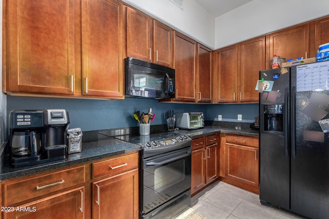 kitchen with light tile patterned floors and black appliances