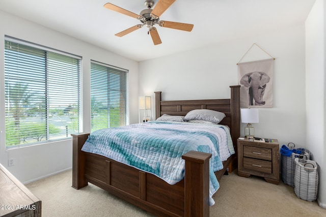 bedroom with ceiling fan and light carpet