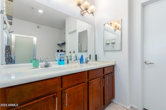 bathroom with vanity and a shower with shower door