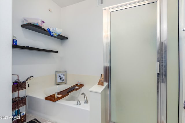 bathroom featuring tile patterned flooring and shower with separate bathtub