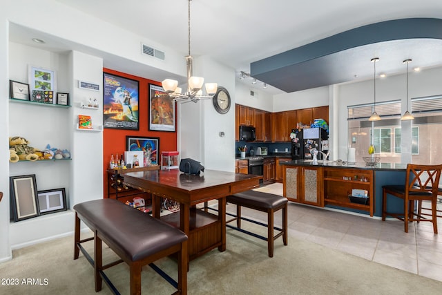 dining room featuring a notable chandelier and light tile patterned floors