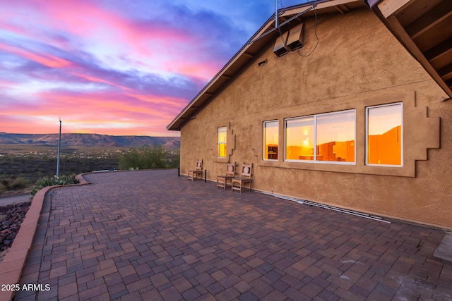 43911 N 13th Ave, New River, AZ 85087 - patio terrace at dusk featuring a mountain view and central air condition unit