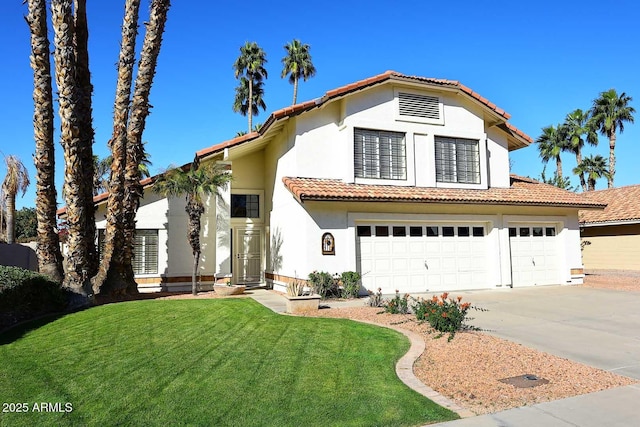 mediterranean / spanish house featuring an attached garage, a tile roof, driveway, stucco siding, and a front lawn