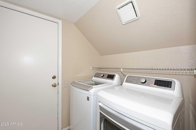 laundry area with laundry area, visible vents, and washer and dryer