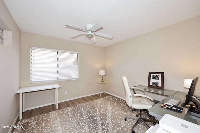 office featuring wood finished floors, a ceiling fan, and baseboards