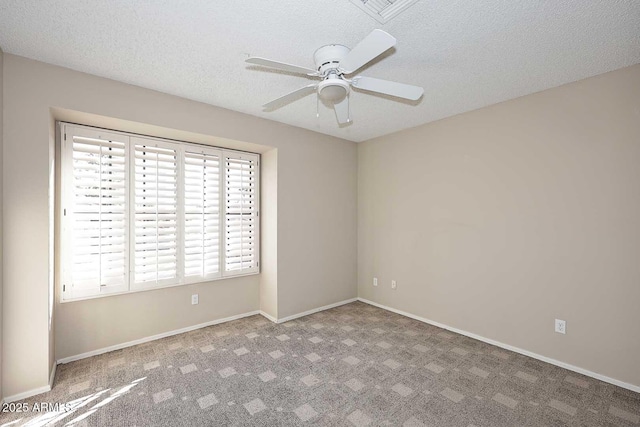 empty room featuring a textured ceiling, carpet flooring, a ceiling fan, and baseboards