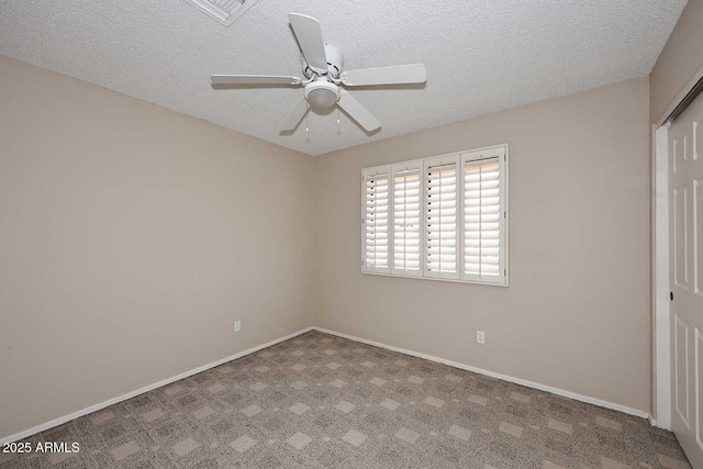 unfurnished bedroom with carpet floors, a closet, ceiling fan, a textured ceiling, and baseboards