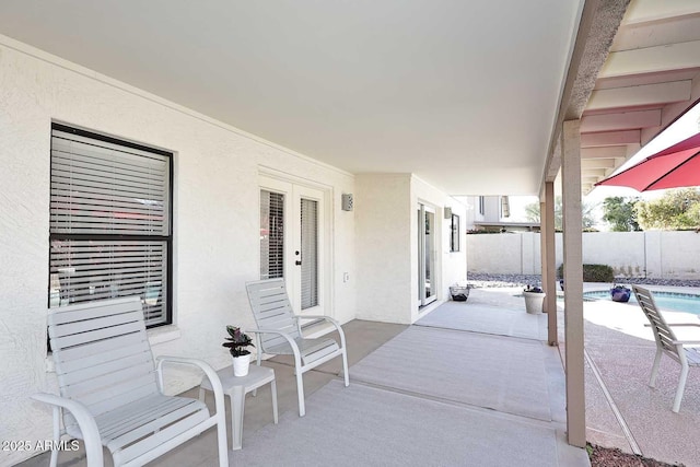 view of patio featuring fence and a fenced in pool