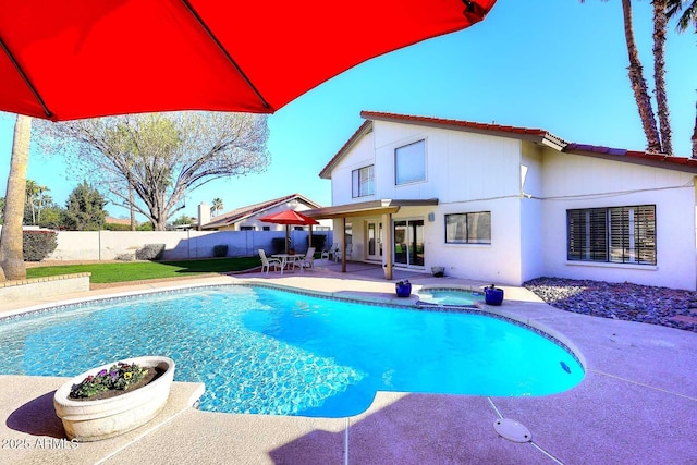 view of swimming pool with a fenced in pool, a patio area, a fenced backyard, and an in ground hot tub