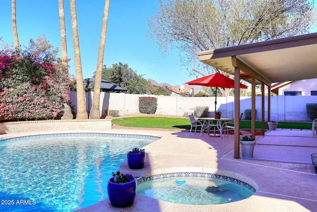 view of swimming pool featuring an in ground hot tub, a patio area, a fenced backyard, and a fenced in pool