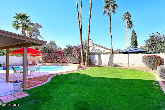 view of yard with a fenced in pool, a patio area, and a fenced backyard