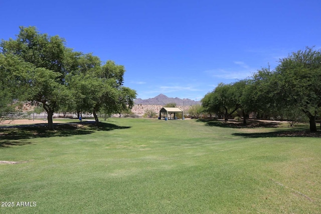 view of community with a mountain view, a lawn, and a gazebo