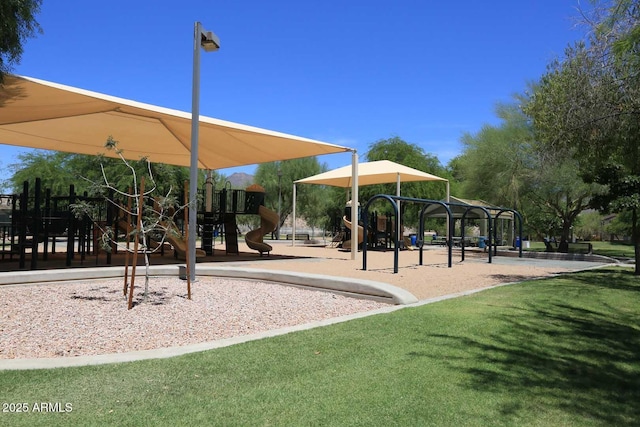 view of property's community featuring playground community and a lawn