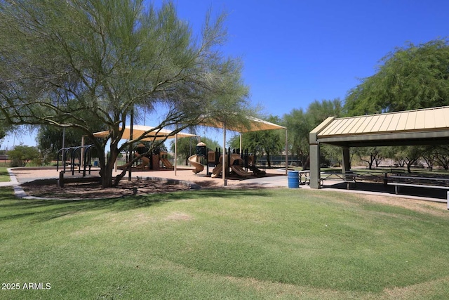 view of property's community with playground community and a yard