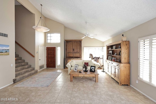 living area with lofted ceiling, stairway, light tile patterned floors, and visible vents