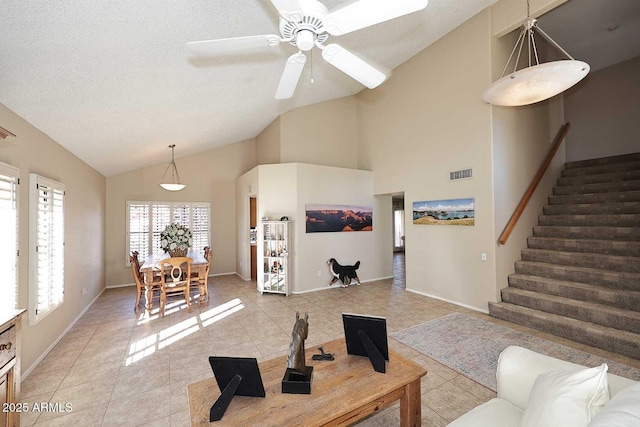 living room with visible vents, stairway, a textured ceiling, and light tile patterned flooring