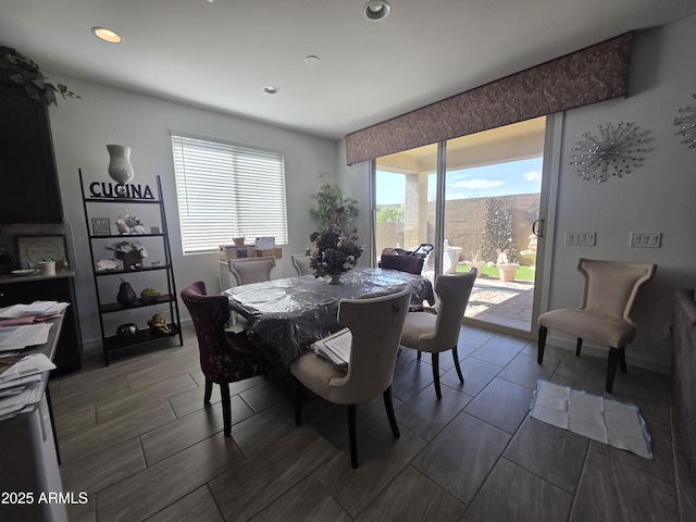 dining room with recessed lighting, baseboards, and wood finish floors