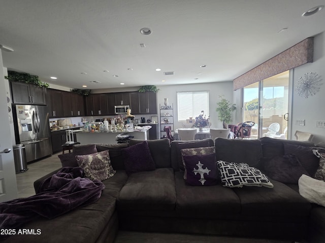 living room with recessed lighting and visible vents