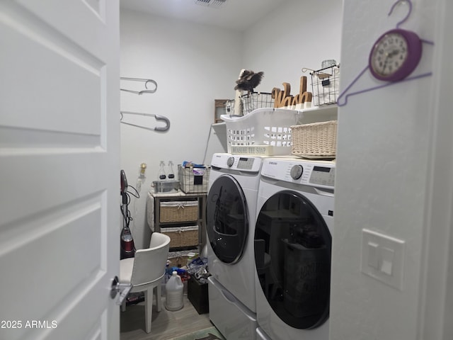 washroom with laundry area, independent washer and dryer, visible vents, and wood finished floors