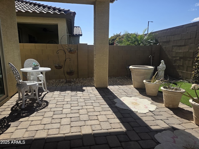 view of patio / terrace featuring fence