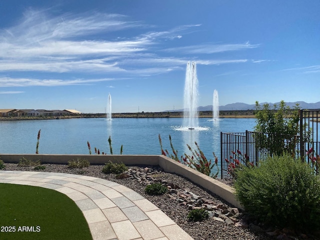 view of water feature featuring a mountain view and fence