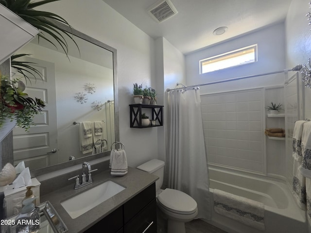 bathroom featuring visible vents, vanity, toilet, and shower / tub combo